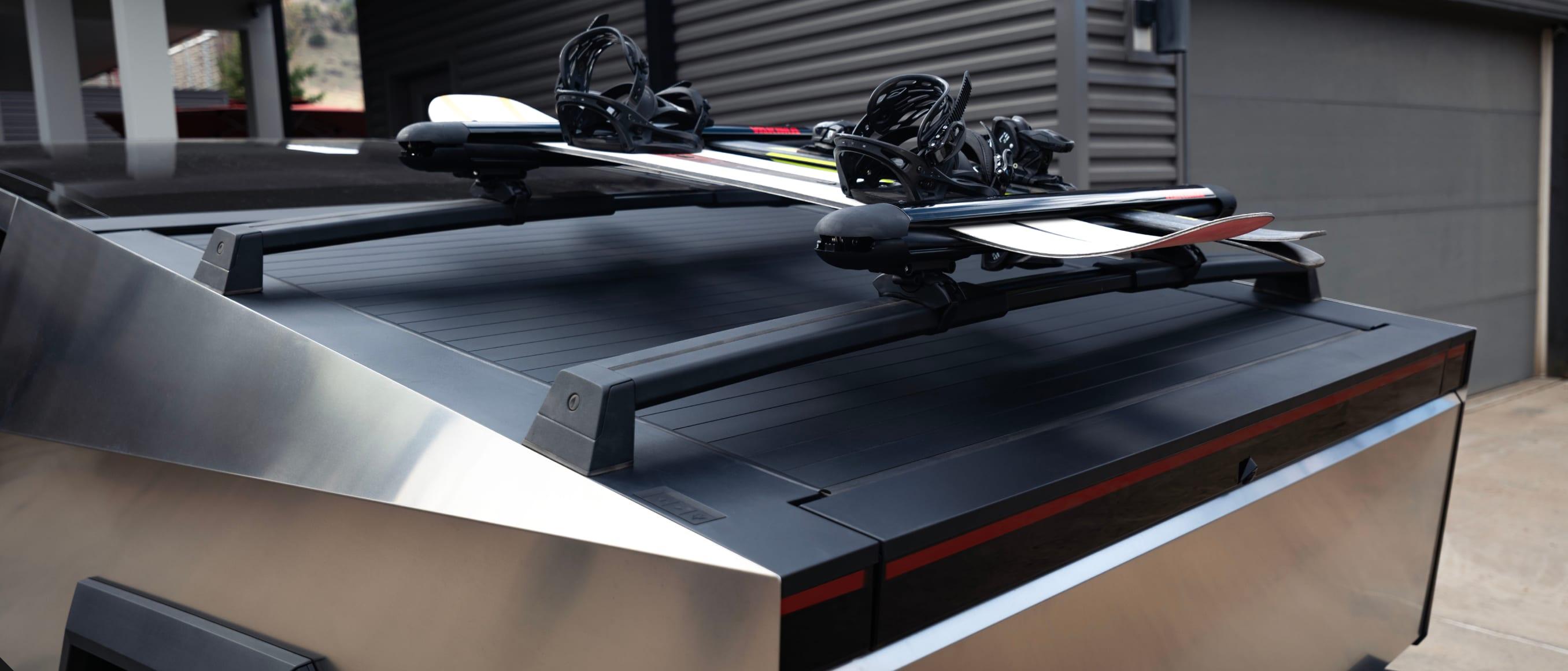Tesla Cybertruck bed with crossbars hauling equipment