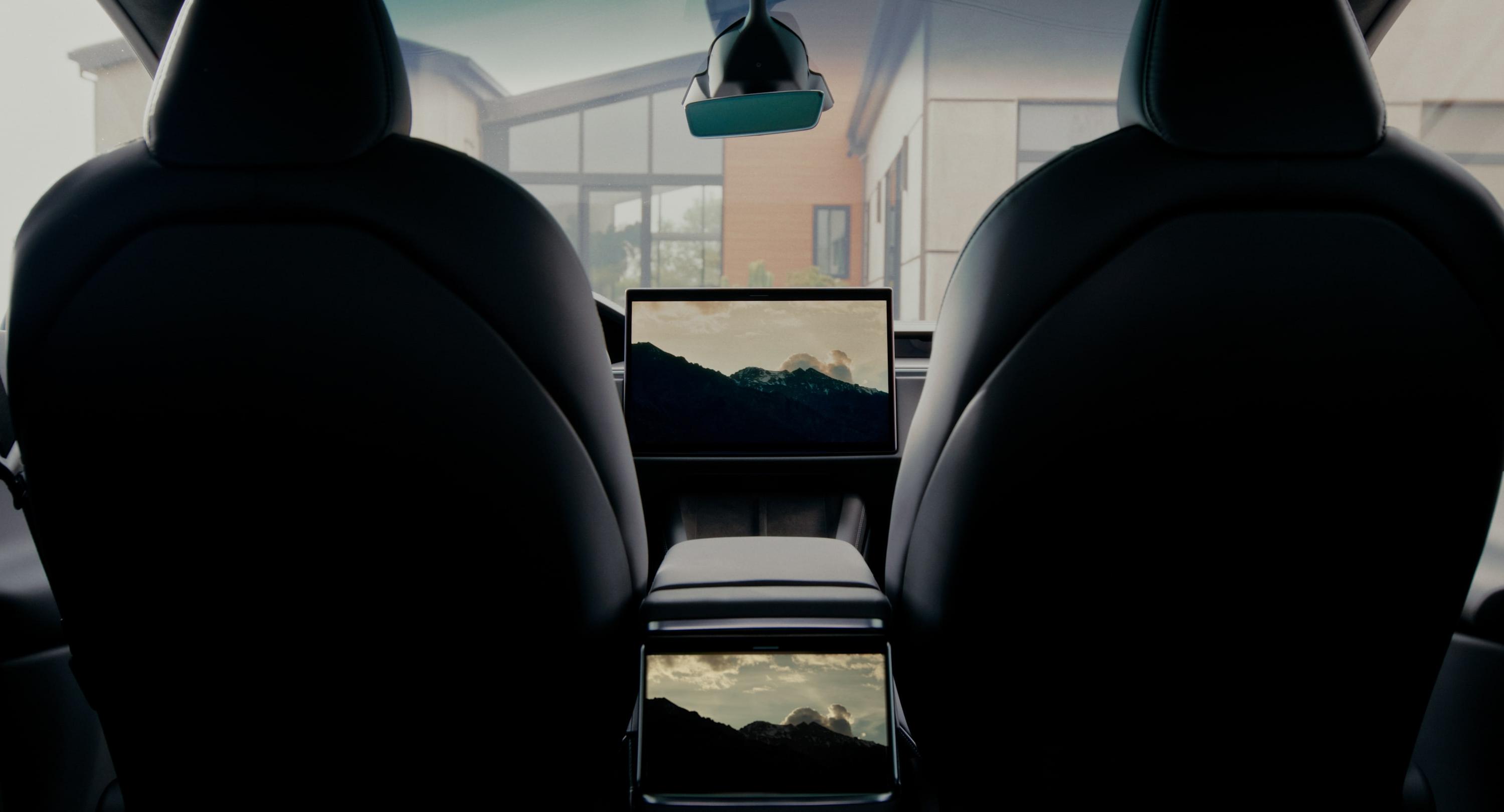 Tesla Model X cabin — panoramic windshield and dual displays